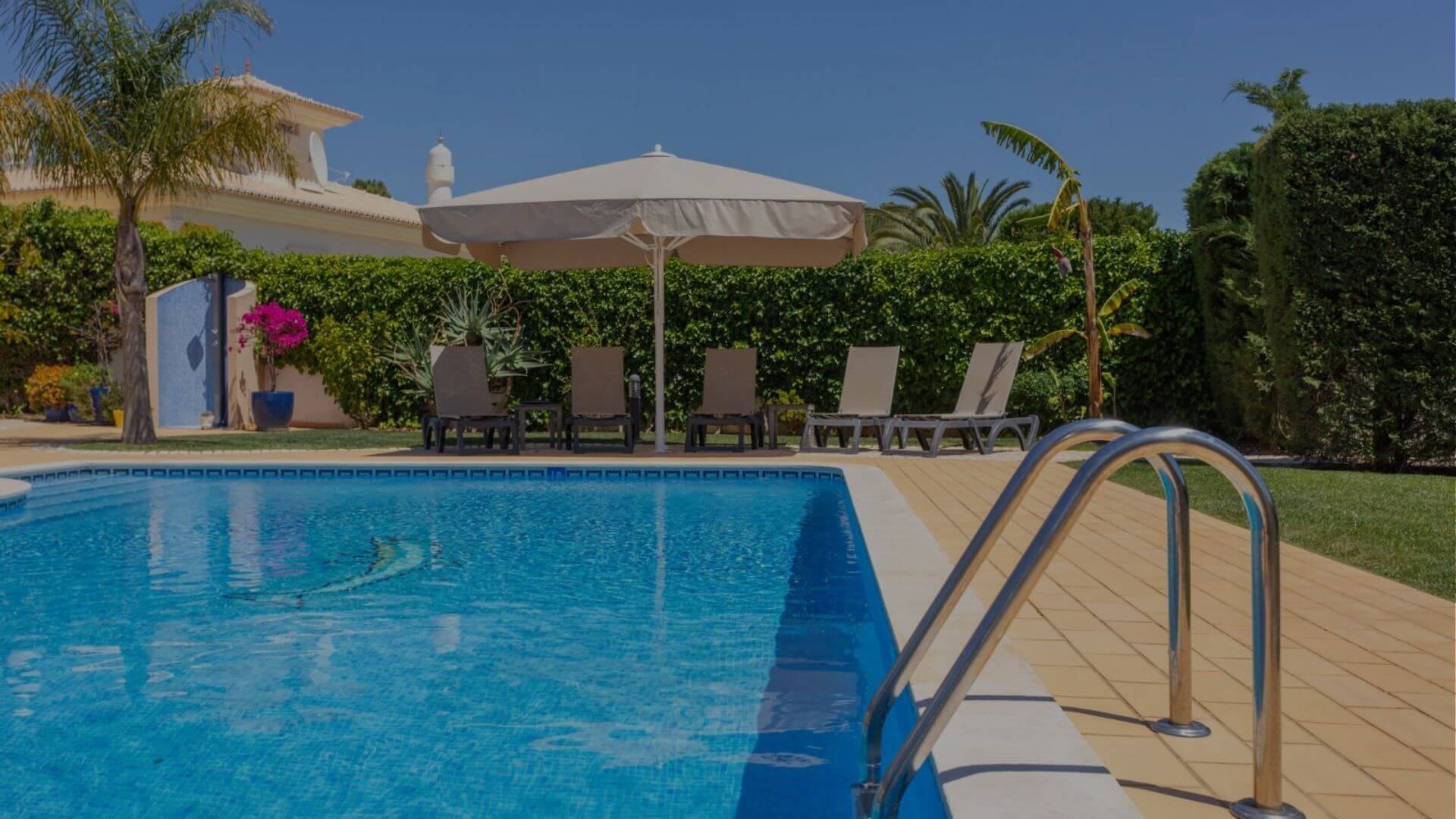 Clean and well-maintained residential swimming pool with lounge chairs and patio area in Brentwood CA